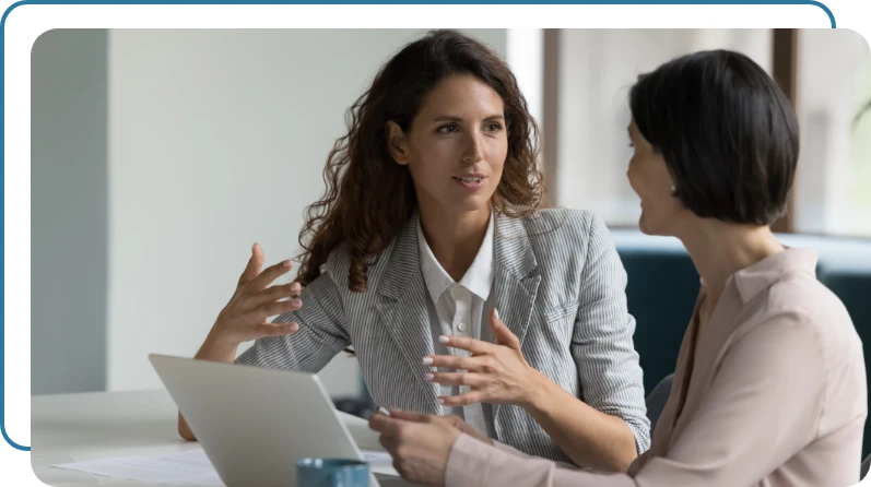 two business women collaborating on a task two business women collaborating on a task